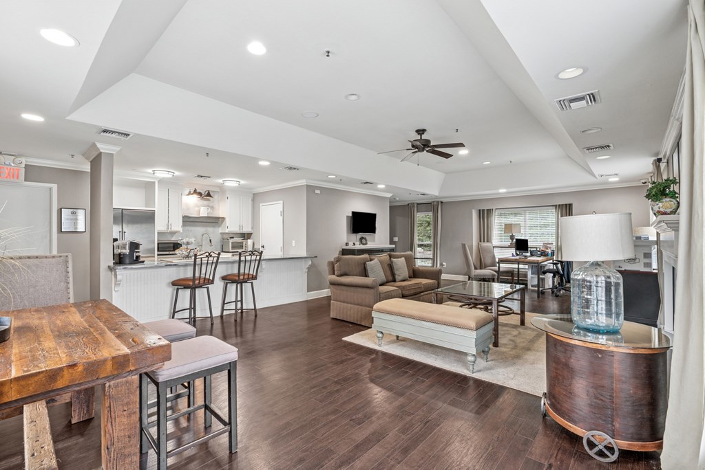 A modern living room with a wooden floor and furniture.