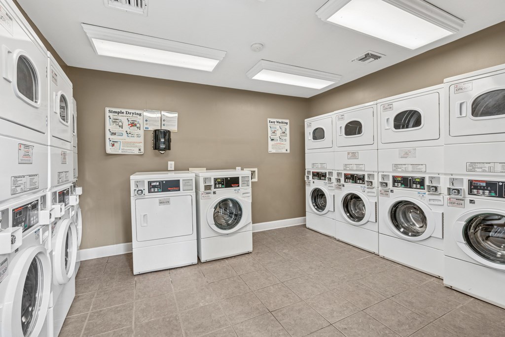 A laundromat with rows of washers and dryers.