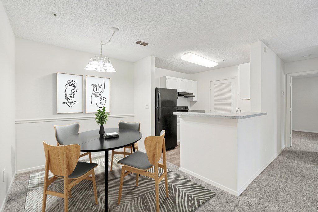 A dining room with a table and chairs.