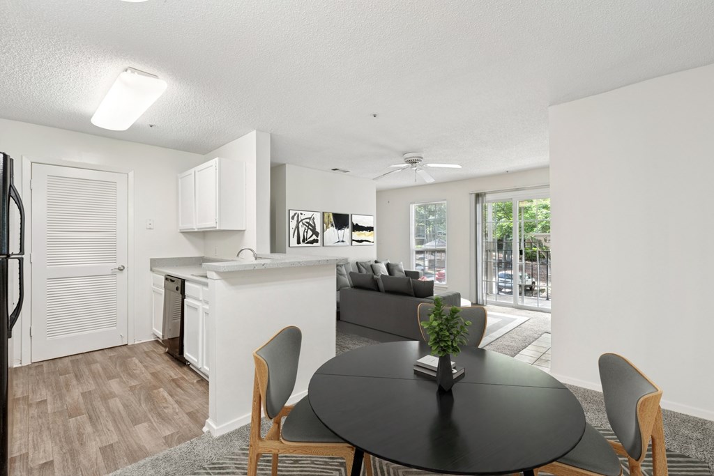 A modern kitchen with a dining table and chairs.