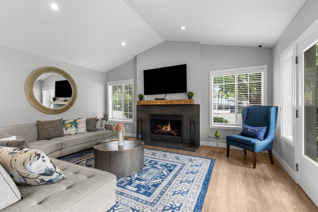 a living room with a couch and a chair and a fireplace