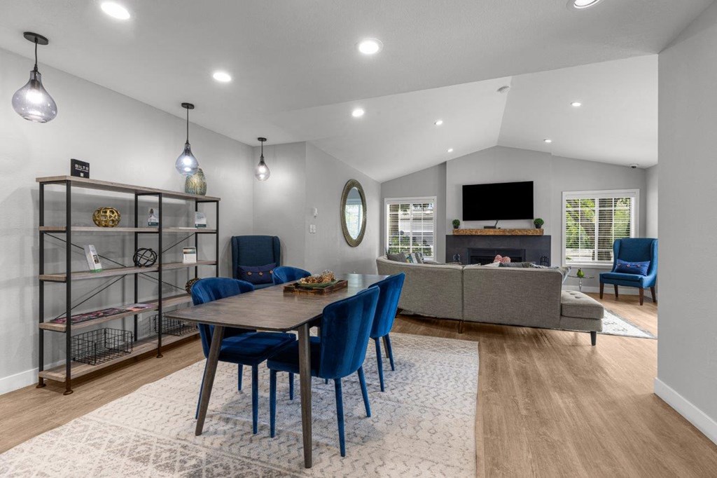 a living room with a table and chairs