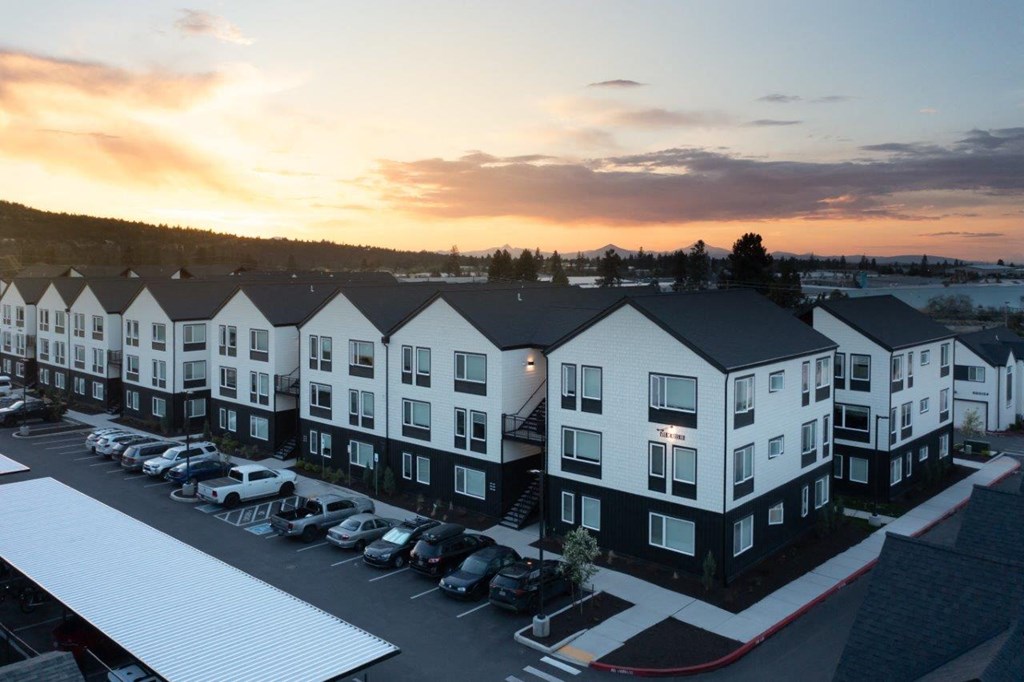 an aerial view of an apartment complex at sunset