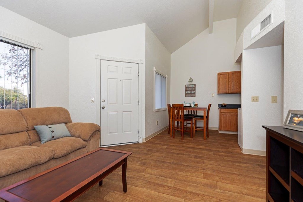 A living room with a brown couch and a wooden coffee table.