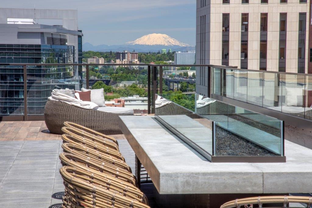 a balcony with a table and chairs and a view of a mountain