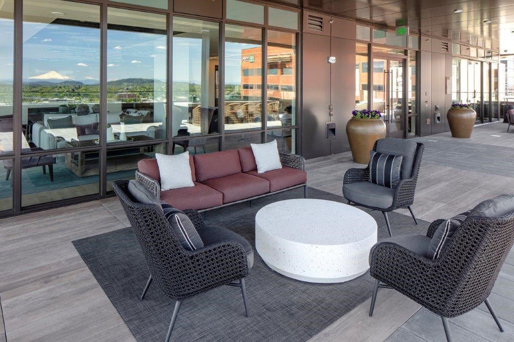 a lounge area with a couch and chairs and a coffee table