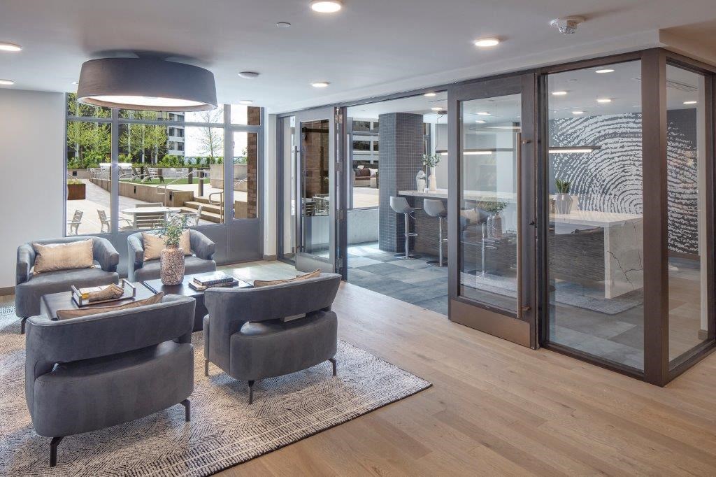 a living room with a couch and chairs and a table