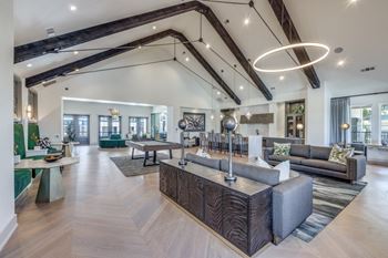 A modern living room with a wooden floor and a large island in the middle.