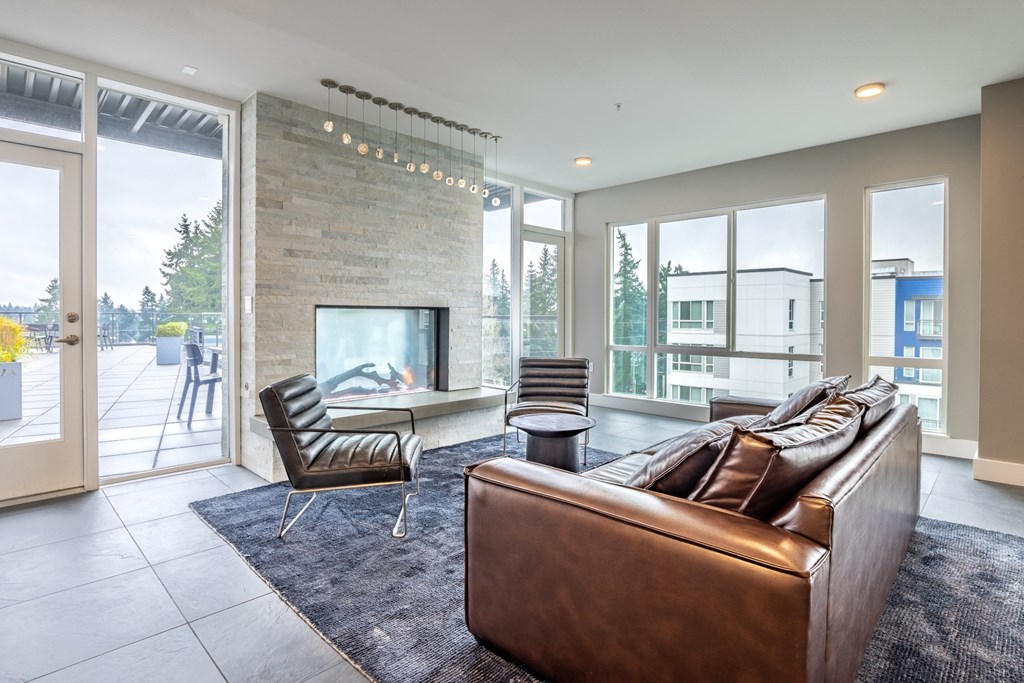 a living room with a leather couch and a fireplace