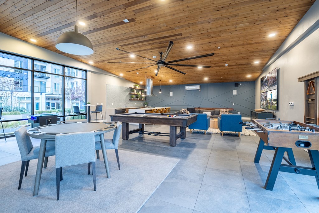 Paceline Apartments game room with a pool table and foosball