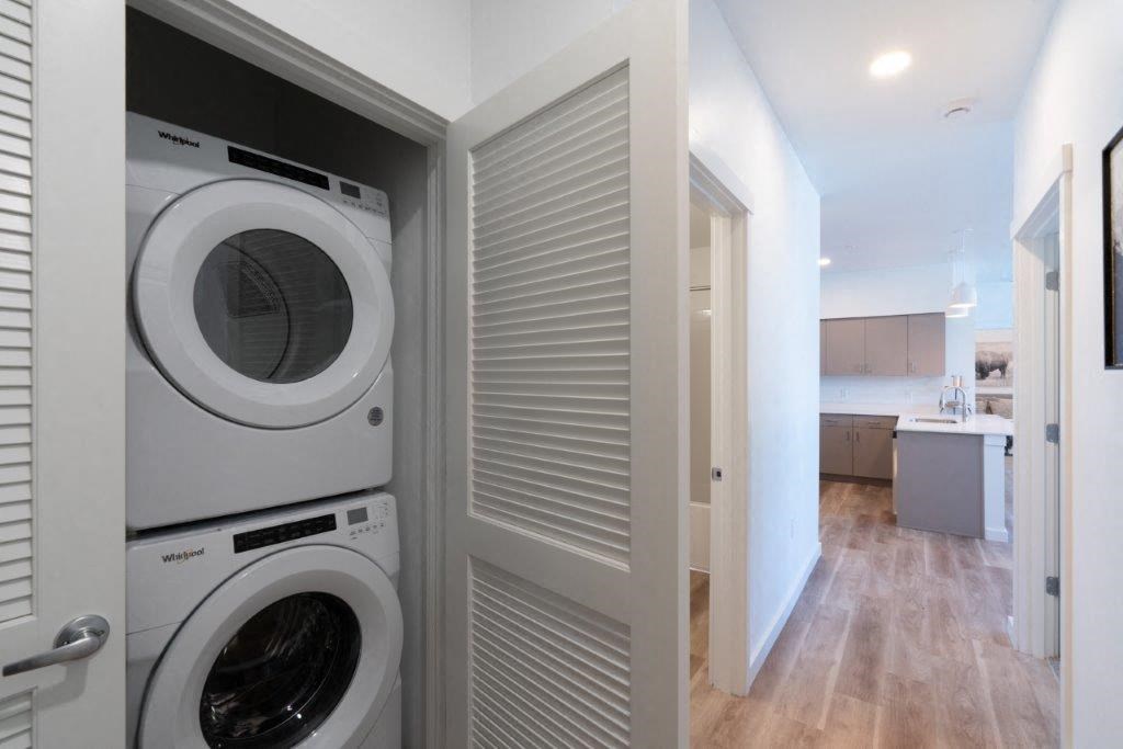 a washer and dryer in a room with a wood floor