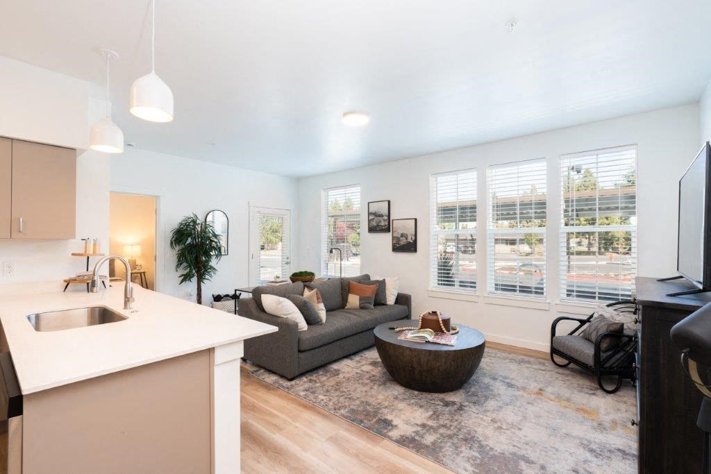 a white living room with purple and pink lights