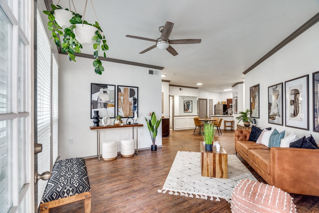a living room with a couch and a ceiling fan
