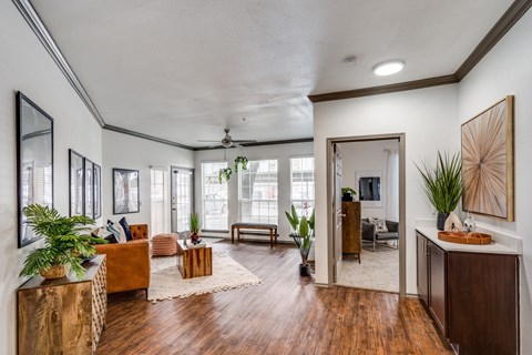 the view of a living room with wood floors and white walls