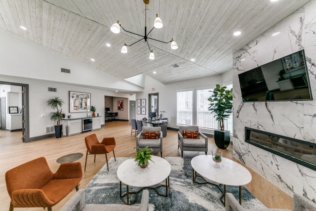 a living room with couches and chairs and a fireplace