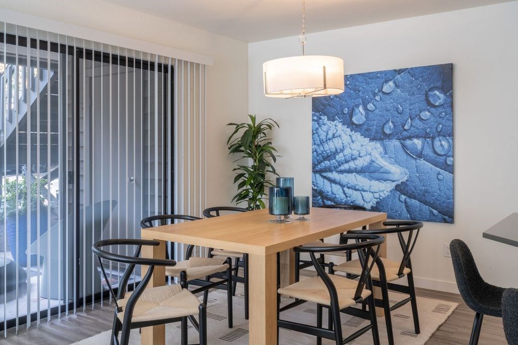 A dining room with a wooden table and chairs.