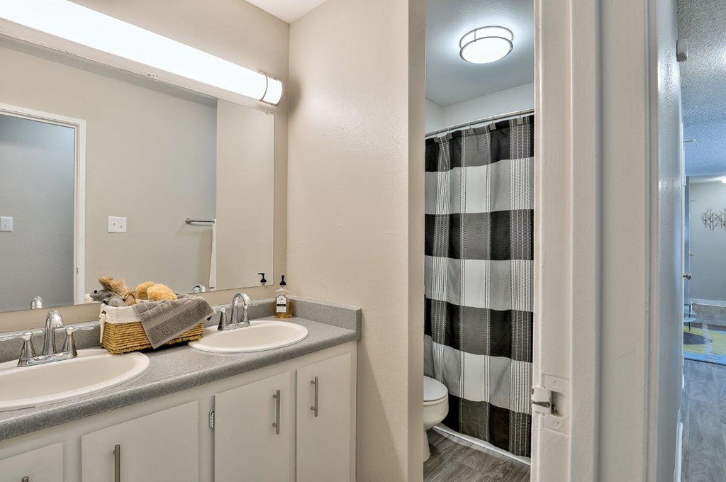 a bathroom with two sinks and a shower
