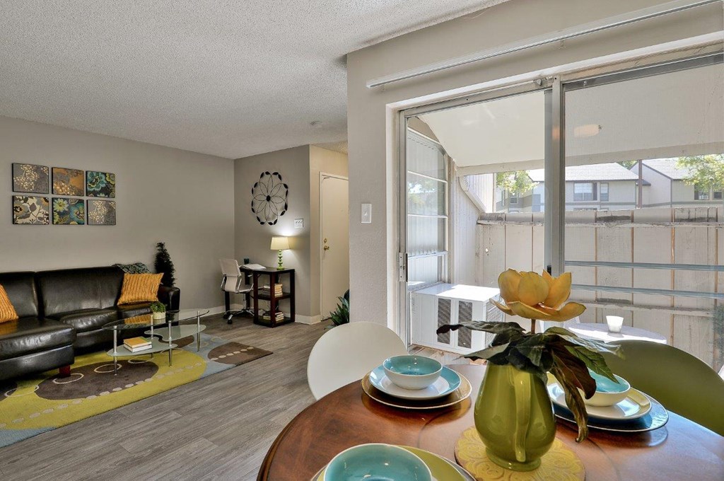 a living room with a table and a large window