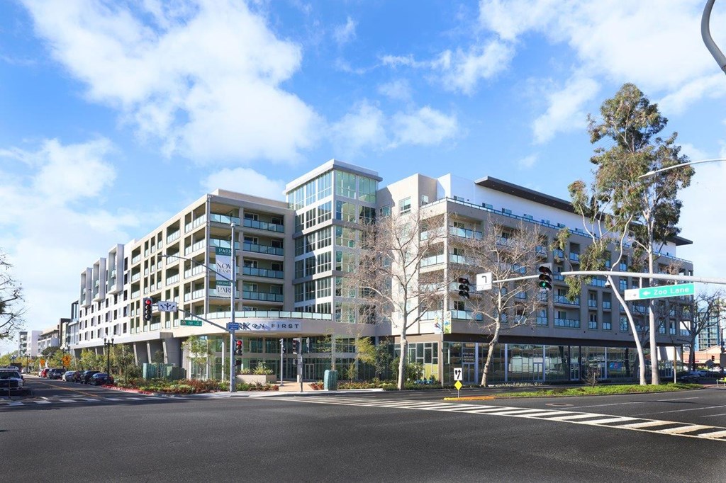 a rendering of a large building at the corner of a street