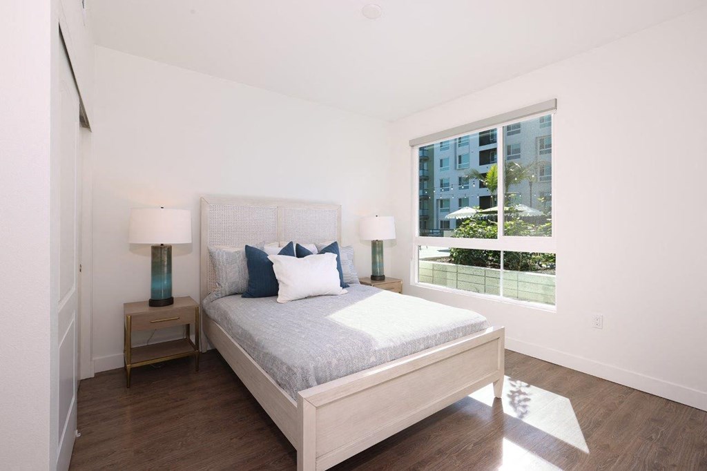 a bedroom with a bed and a window