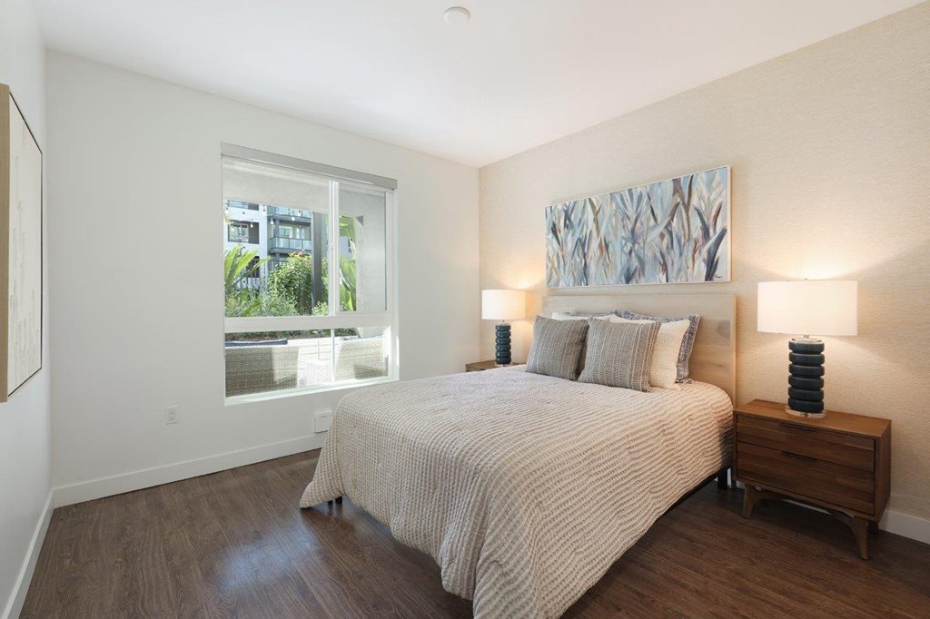 a bedroom with a bed and a window