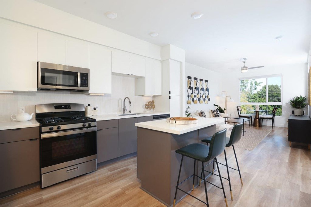 a kitchen with an island and a stove and a microwave