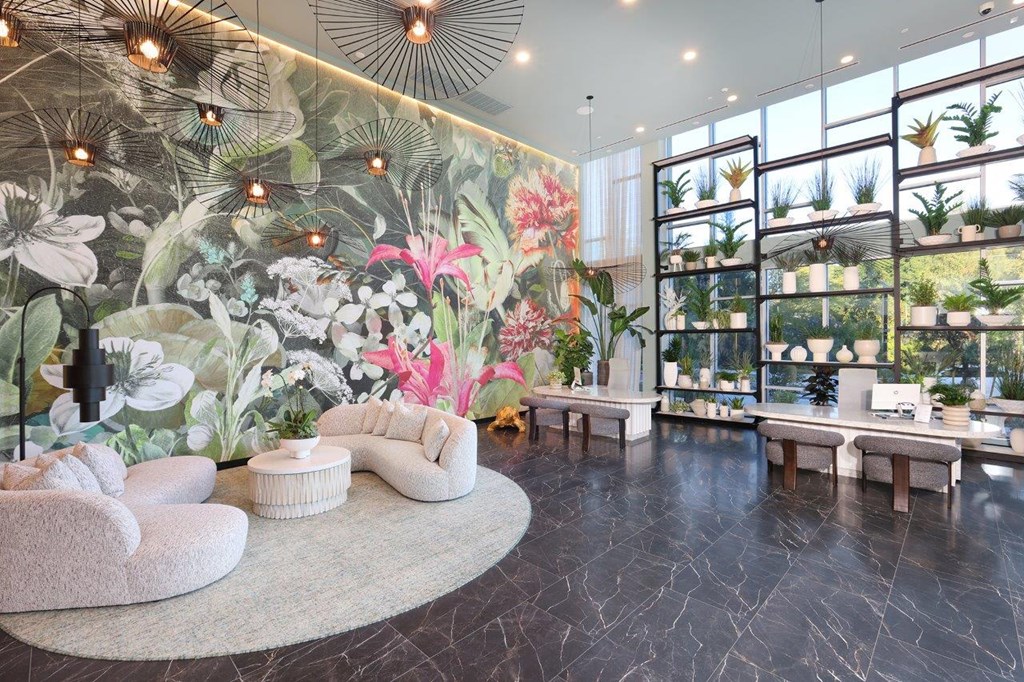 a lobby with a large wall mural of flowers and plants