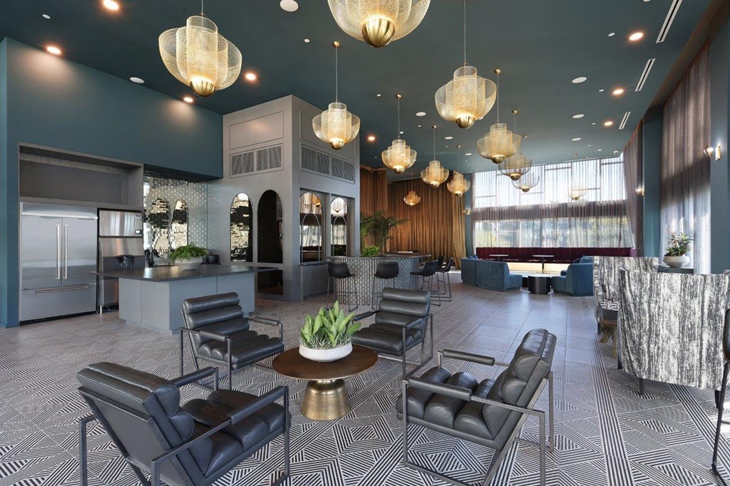the lobby or reception area of a hotel with chairs and tables