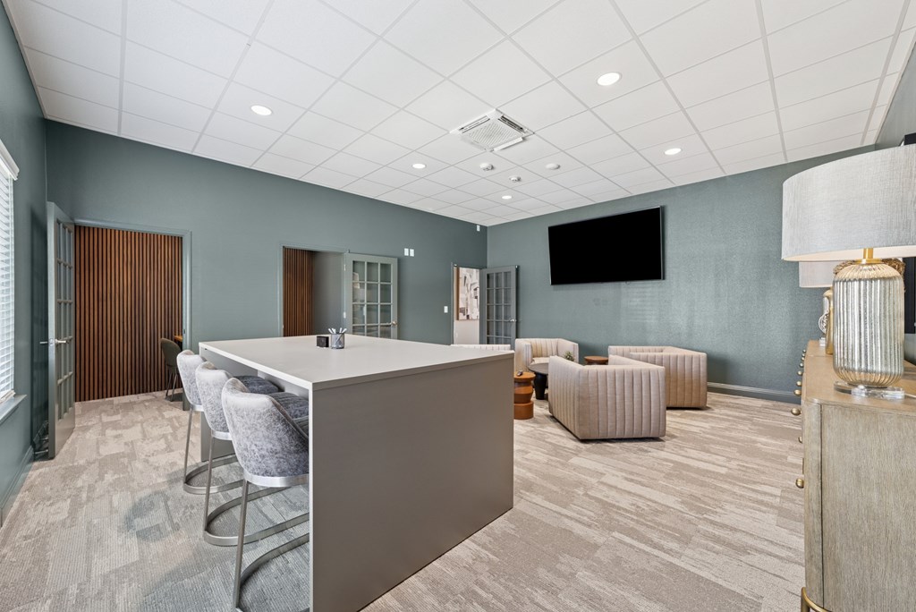 A conference room with a long table and chairs.