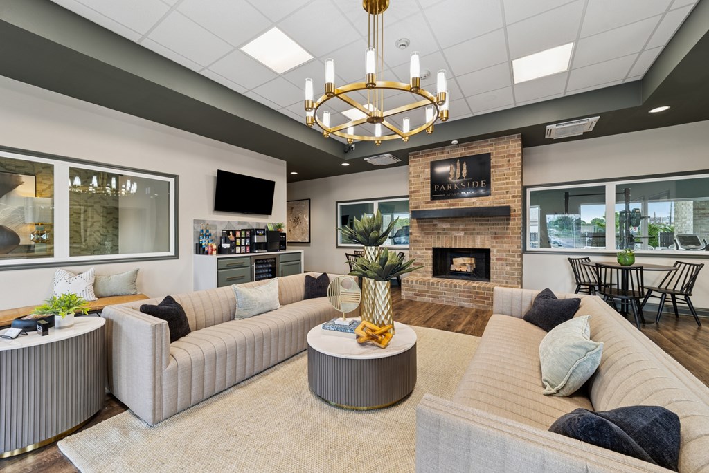 A living room with a fireplace and a pineapple on the coffee table.