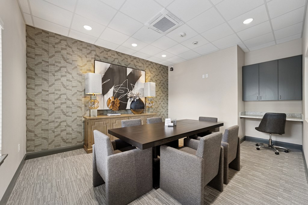 A conference room with a large table and chairs.