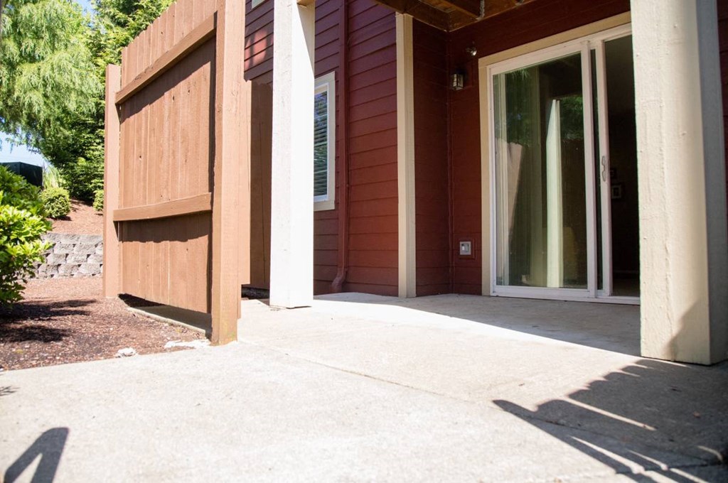 a porch in front of a house with a glass door