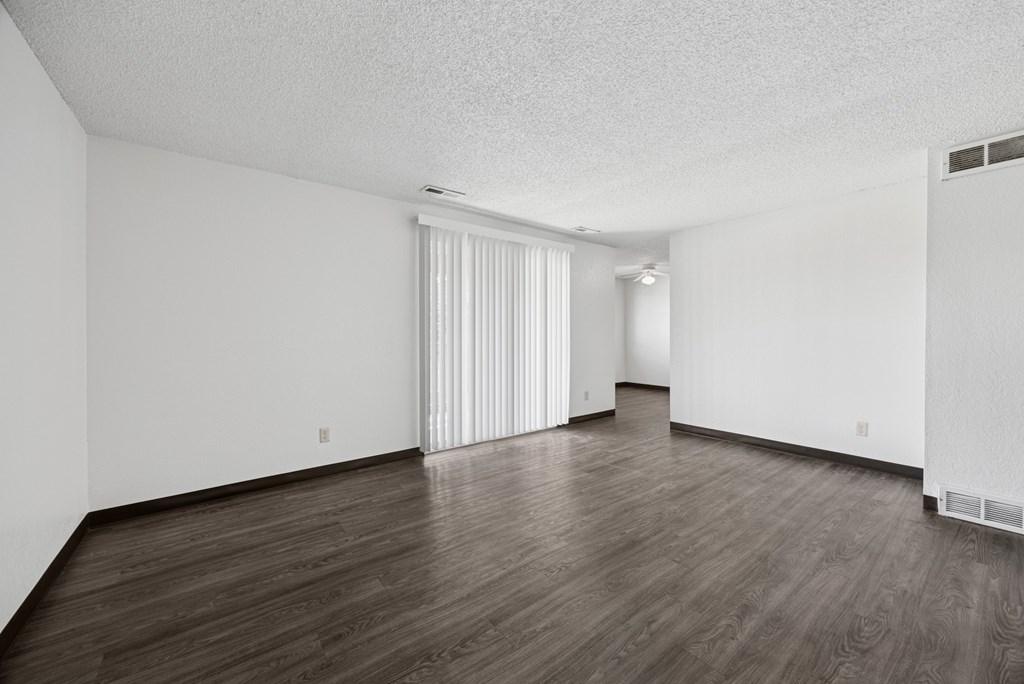 A room with wooden floors and white walls.