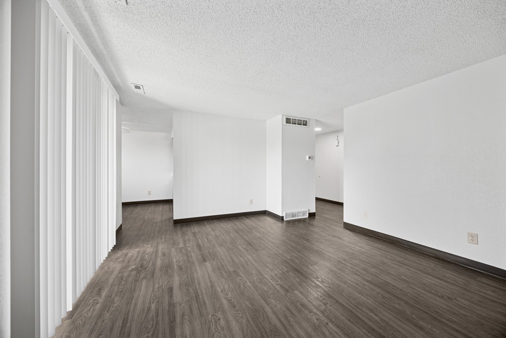 A room with white walls and wood flooring.