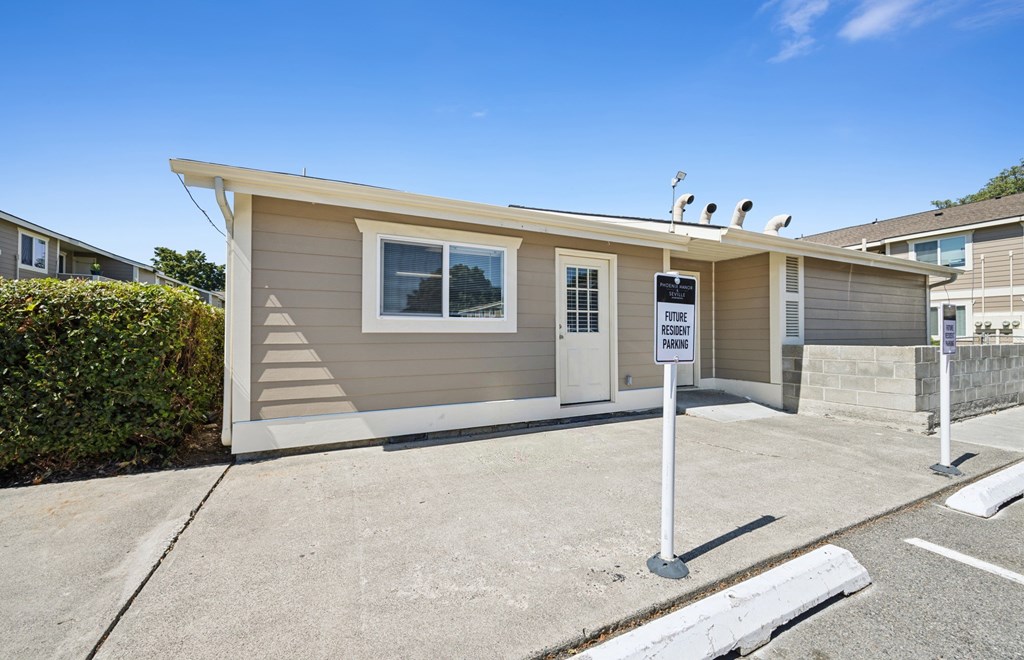 A small house with a sign that says
