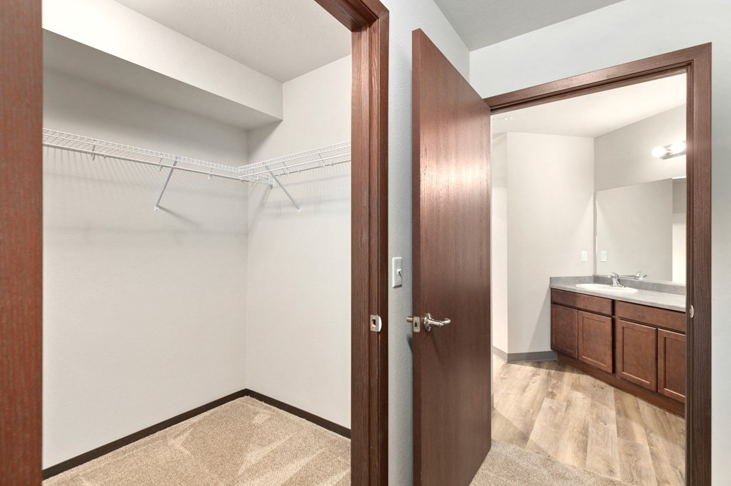 Pioneer Meadows Walk In Closet with View into Bathroom