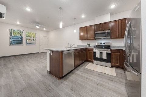 A modern kitchen with a white island and stainless steel appliances.