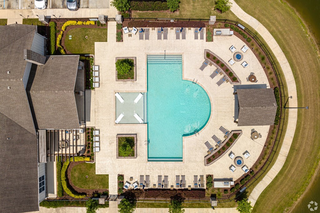 arial view of a resort style swimming pool with chaise lounge chairs