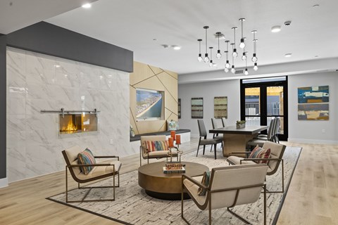 A modern living room with a fireplace and a large painting on the wall.