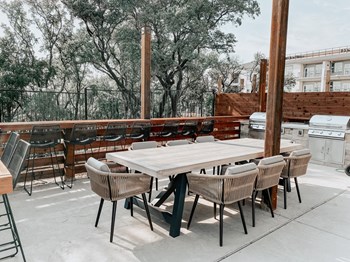 Presidio at River East Outdoor BBQ Area with Large Dining Table - Photo Gallery 17