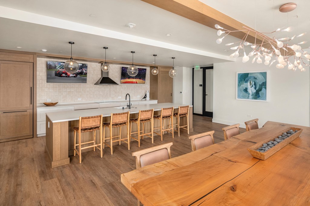 a kitchen and dining room with a wooden table and chairs
