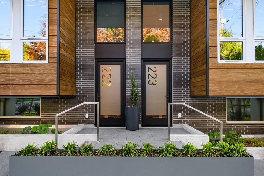 the facade of a building with brick and glass doors