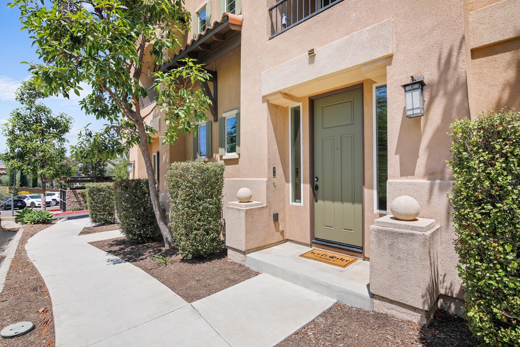 the entrance to an apartment building with a green door