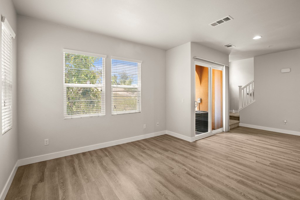 a living room with a large window and a door to a bathroom