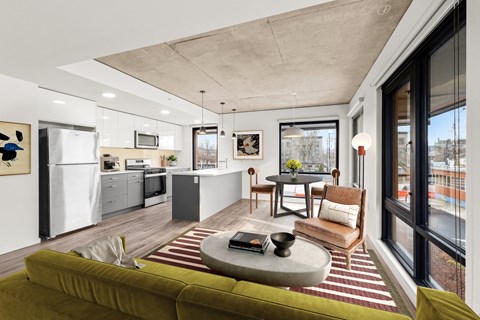 A modern living room with a green sofa and a coffee table.