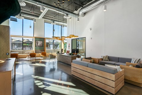 A modern living room with a long couch and a coffee table.