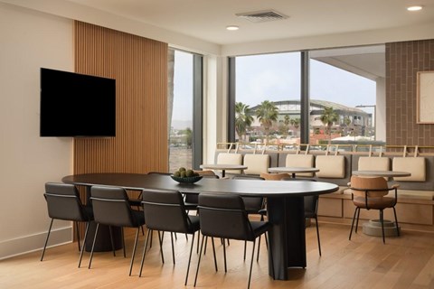 A modern dining room with a large table and chairs.