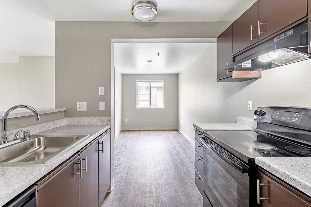 a kitchen with stainless steel appliances and white quartz countertops