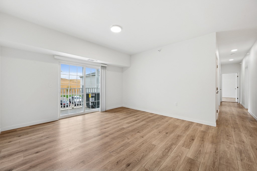 A room with wooden floors and white walls.