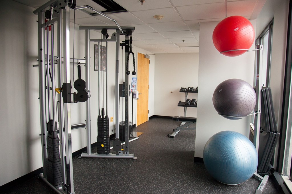 a fitness room with exercise equipment and a ball